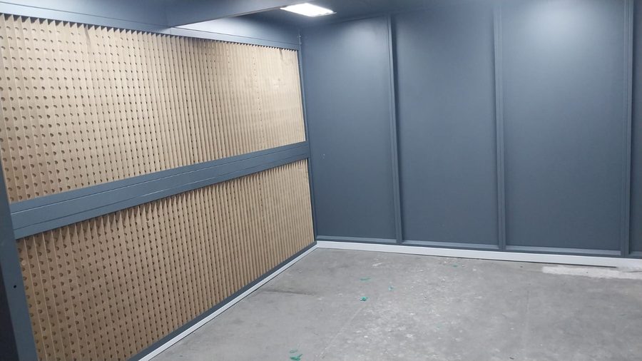Dark grey panelled booth, paper filter wall
